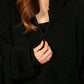 Close-up of The Teddy Bear Quarter-Zip wearable blanket in black highlighting quarter-zip neckline and plush CloudSherpa™ fabric