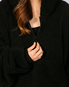 Close-up of The Teddy Bear Quarter-Zip wearable blanket in black highlighting quarter-zip neckline and plush CloudSherpa™ fabric