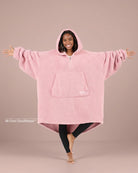 Front view of The Teddy Bear Quarter-Zip wearable blanket in blush showing oversized fit and all-over CloudSherpa™ fabric with hood up