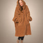 Front view of The Teddy Bear Quarter-Zip wearable blanket in camel showing relaxed oversized silhouette with hood up and hands tucked inside