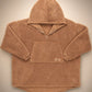 Flat lay of The Teddy Bear Quarter-Zip wearable blanket in camel displaying full shape, hood, front pocket, and all-over CloudSherpa™ construction