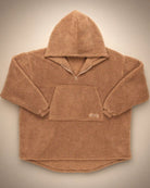 Flat lay of The Teddy Bear Quarter-Zip wearable blanket in camel displaying full shape, hood, front pocket, and all-over CloudSherpa™ construction