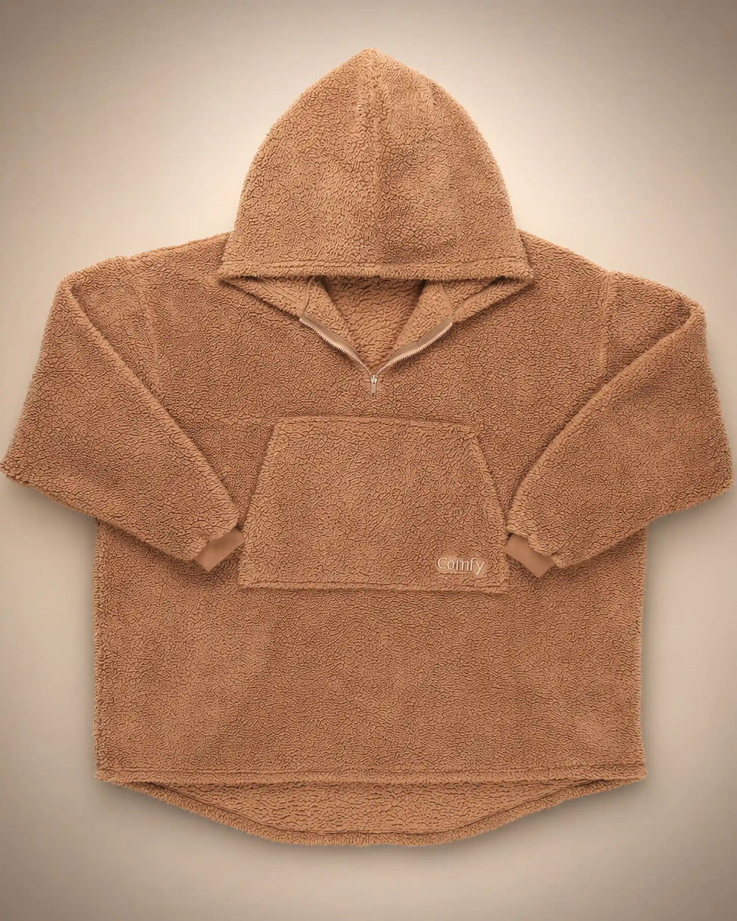 Flat lay of The Teddy Bear Quarter-Zip wearable blanket in camel displaying full shape, hood, front pocket, and all-over CloudSherpa™ construction