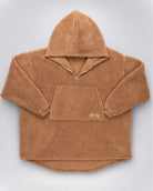 Flat lay of The Teddy Bear Quarter-Zip wearable blanket in camel displaying full shape, hood, front pocket, and all-over CloudSherpa™ construction