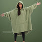 Front view of The Teddy Bear Quarter-Zip wearable blanket in cucumber showing oversized fit and all-over CloudSherpa™ fabric with hood up and arms extended