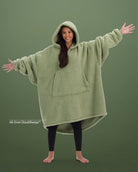 Front view of The Teddy Bear Quarter-Zip wearable blanket in cucumber showing oversized fit and all-over CloudSherpa™ fabric with hood up and arms extended