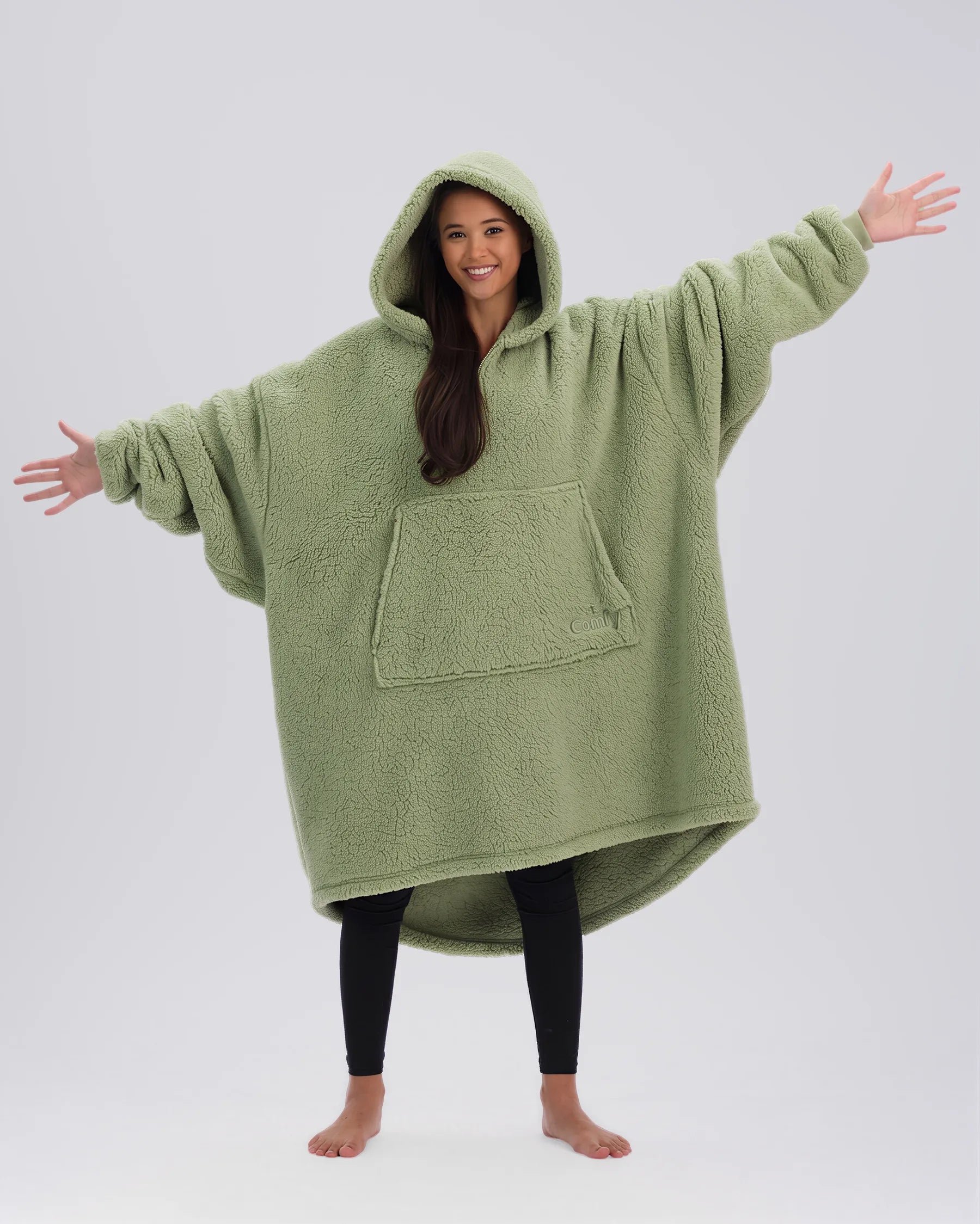 Front view of The Teddy Bear Quarter-Zip wearable blanket in cucumber showing oversized fit and all-over CloudSherpa™ fabric with hood up and arms extended