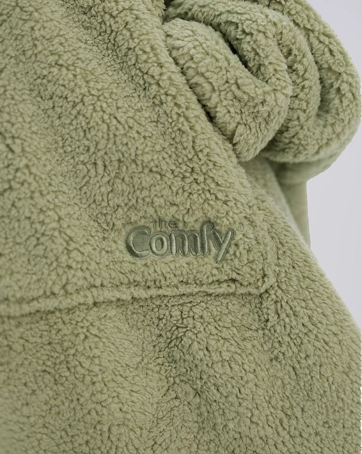 Close-up of The Teddy Bear Quarter-Zip wearable blanket in cucumber showing sleeve detail and embroidered logo on soft CloudSherpa™ fabric