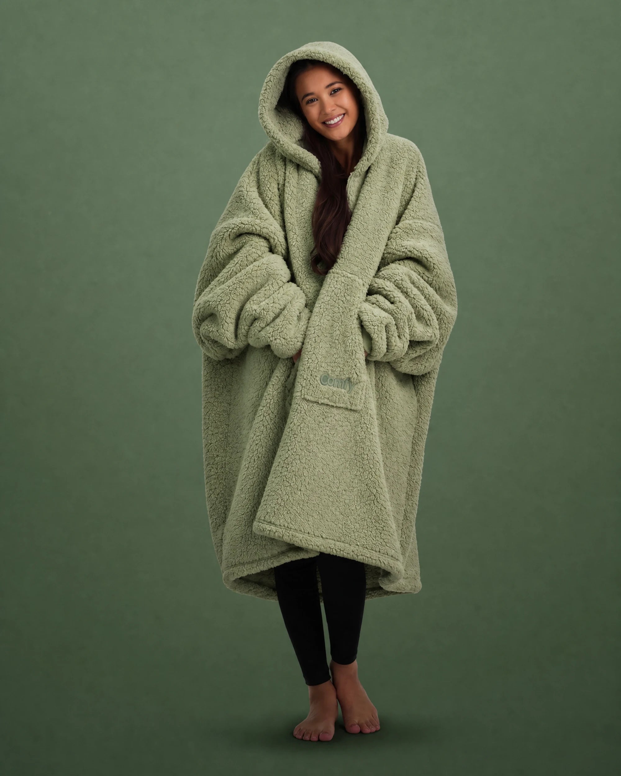 Front view of The Teddy Bear Quarter-Zip wearable blanket in cucumber with model wrapped in oversized fit showing full coverage and cozy silhouette