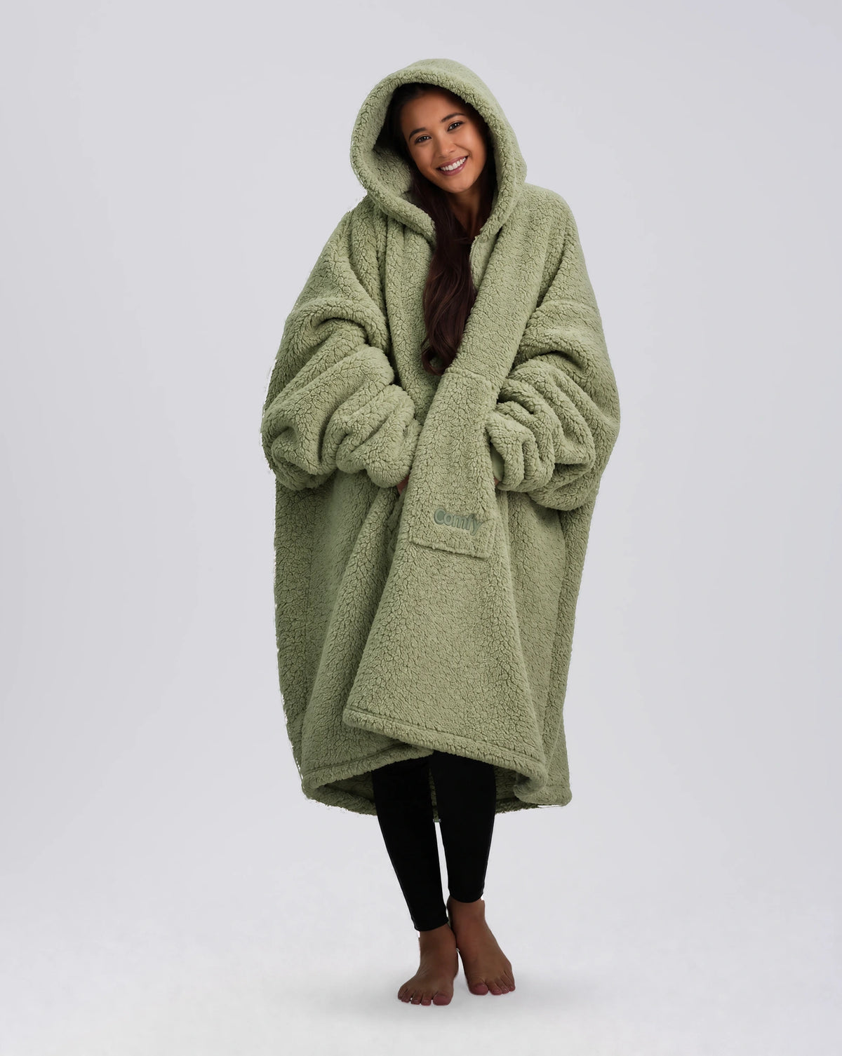 Front view of The Teddy Bear Quarter-Zip wearable blanket in cucumber with model wrapped in oversized fit showing full coverage and cozy silhouette
