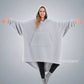 Front view of The Teddy Bear Quarter-Zip wearable blanket in light gray showing oversized fit and all-over CloudSherpa™ fabric with hood up and arms extended
