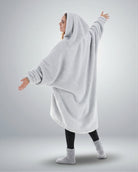 Back view of The Teddy Bear Quarter-Zip wearable blanket in light gray highlighting oversized drape and hooded silhouette