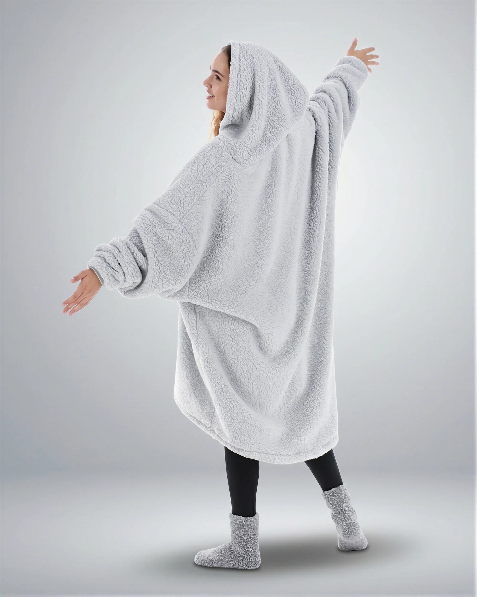 Back view of The Teddy Bear Quarter-Zip wearable blanket in light gray highlighting oversized drape and hooded silhouette