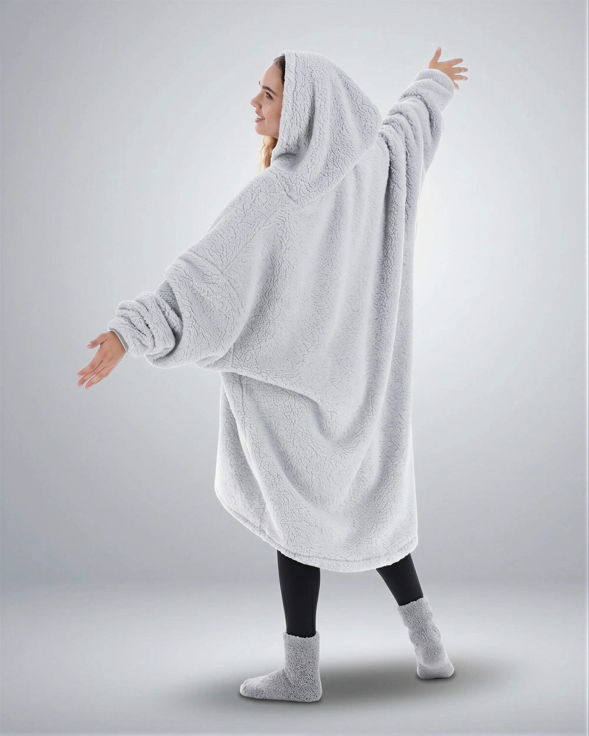 Back view of The Teddy Bear Quarter-Zip wearable blanket in light gray highlighting oversized drape and hooded silhouette