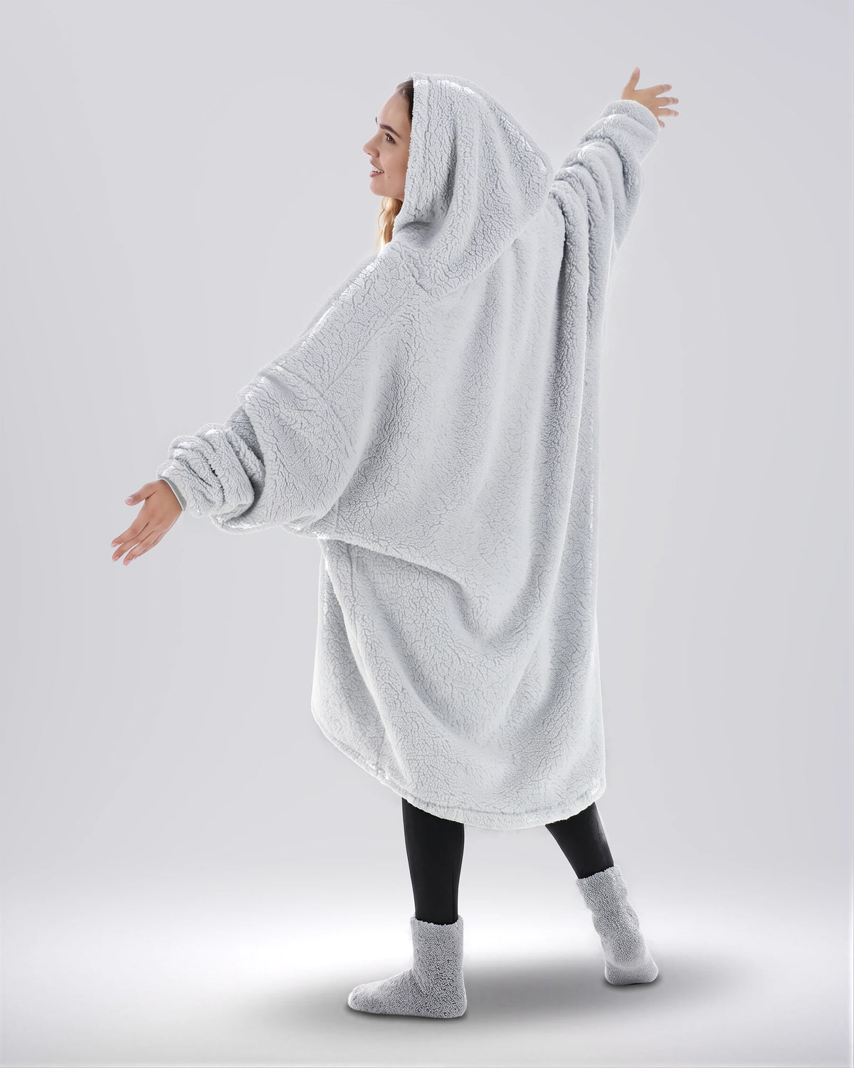 Back view of The Teddy Bear Quarter-Zip wearable blanket in light gray highlighting oversized drape and hooded silhouette