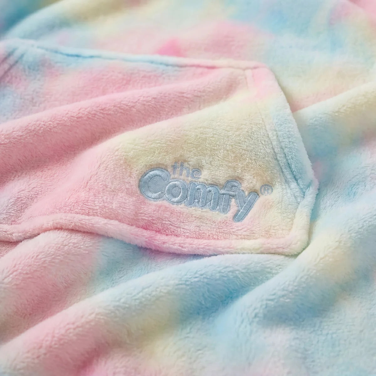 Close-up of cotton candy DreamHaven™ fabric with The Comfy embroidery.